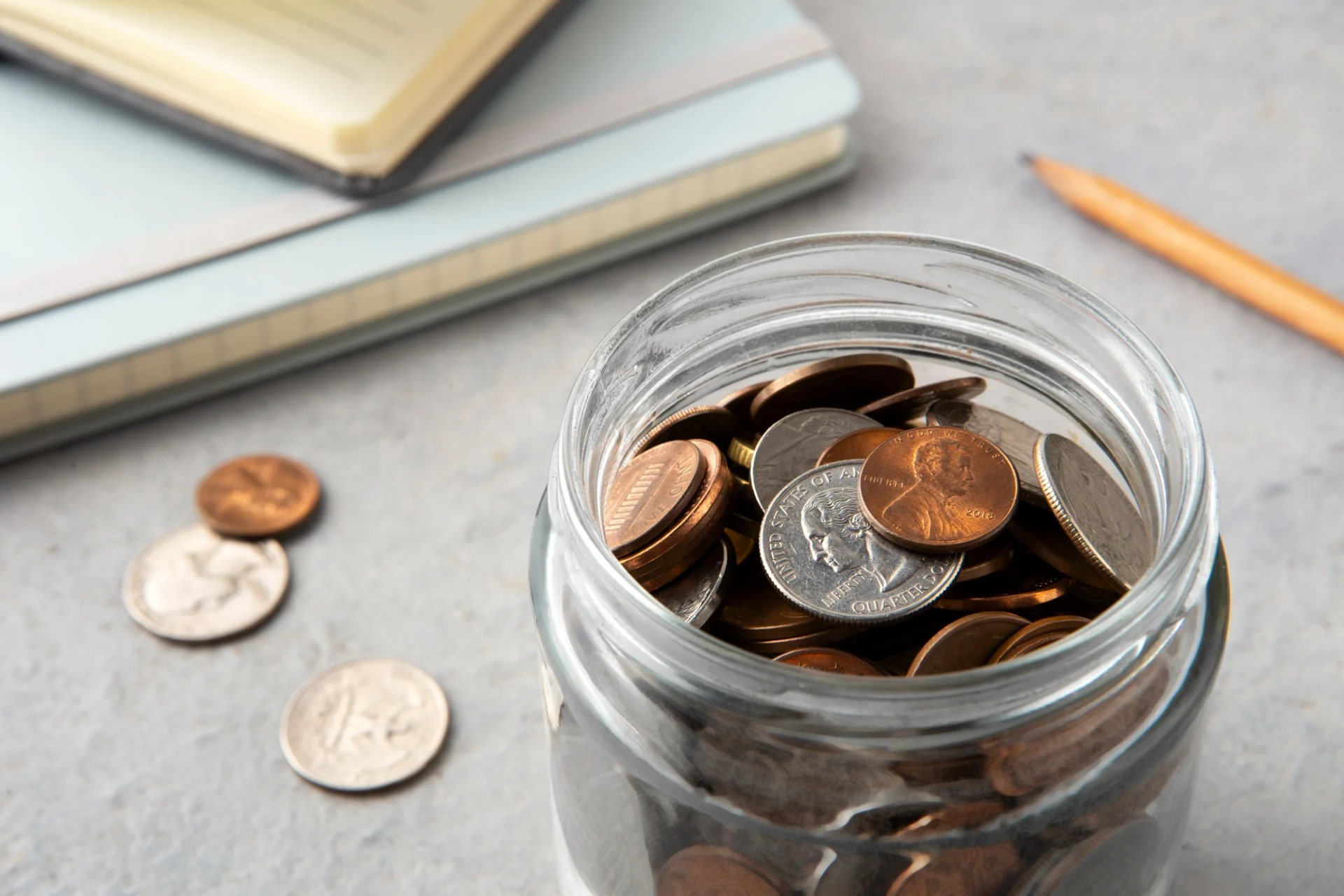 A pot of coins sat on a desk representing that a client doesn't have a lot but knows their still need a will.
