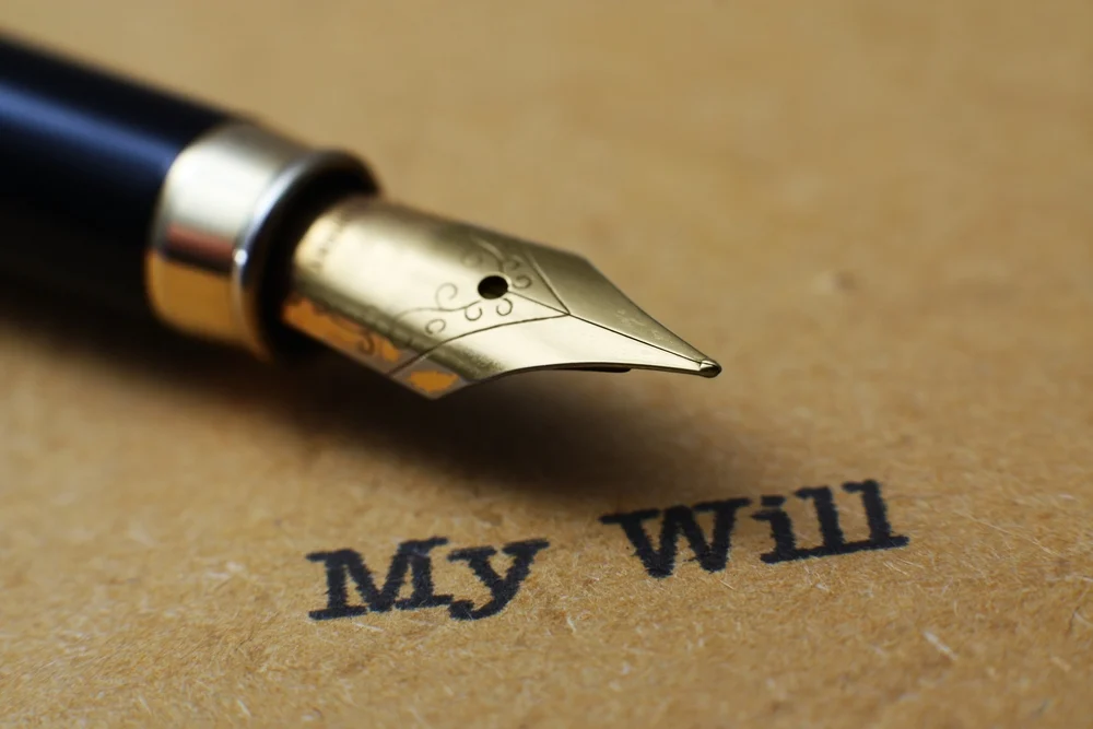 A fountain pen lying on top of a will.