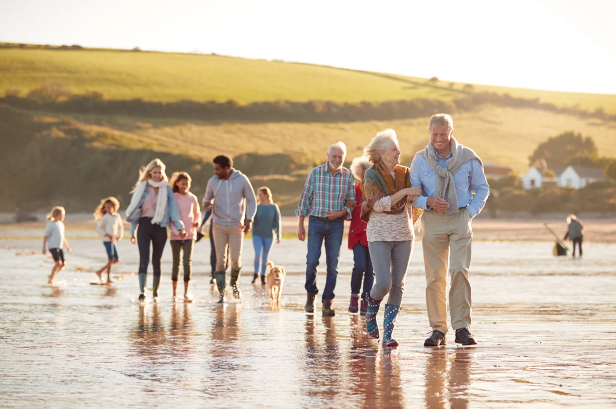 A family walking on the beach knowing their wills are in place.