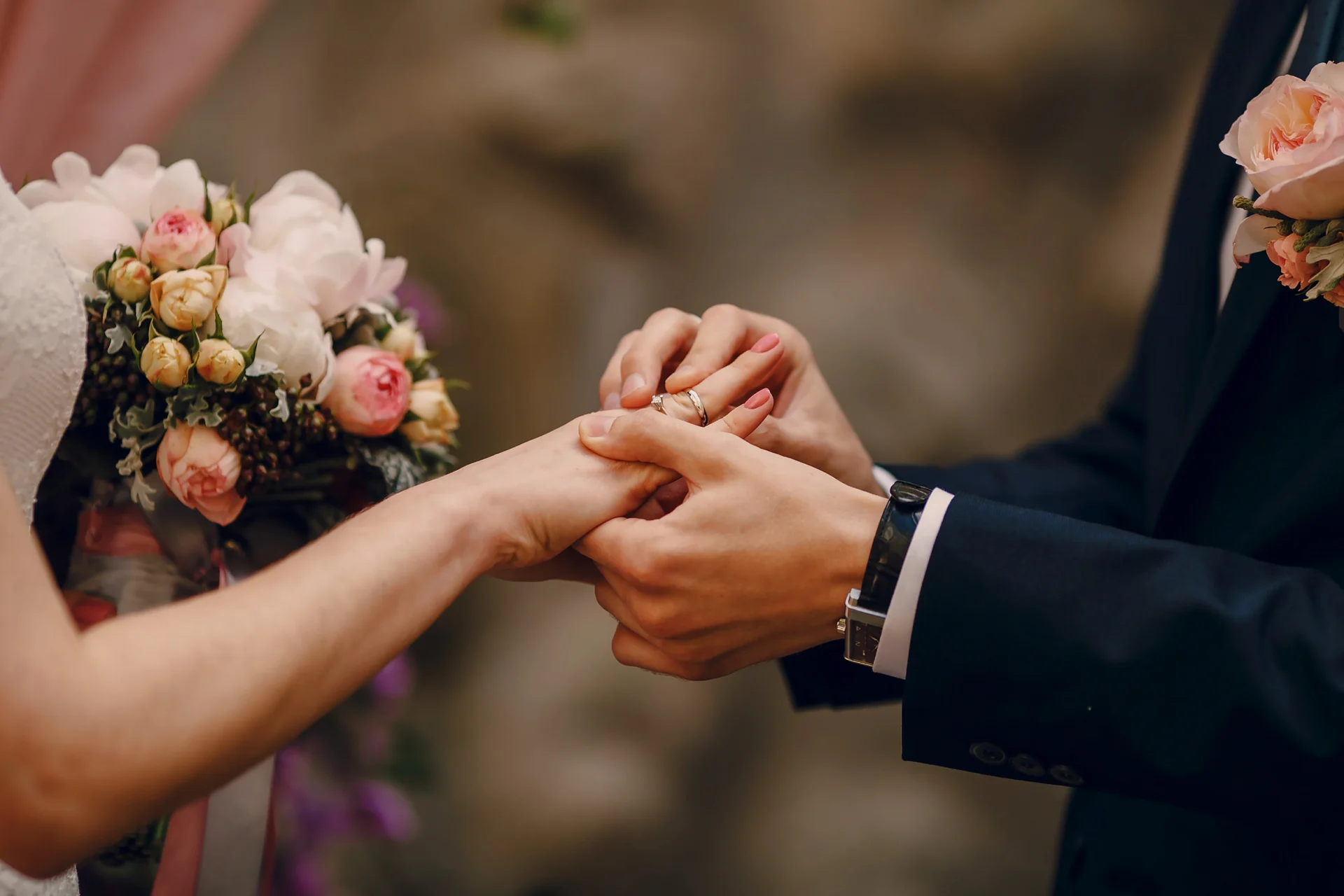 A picture of a bridge and groom with the groom putting a ring onto the wife's finger. They've put their wills in place to ensure their wedding doesn't revoke any previous will.